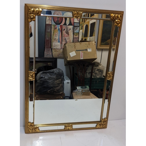 434 - A modern gilt framed mirror with floral ornament, measurements 69cm x 95cm
Location: RWM
If there is... 