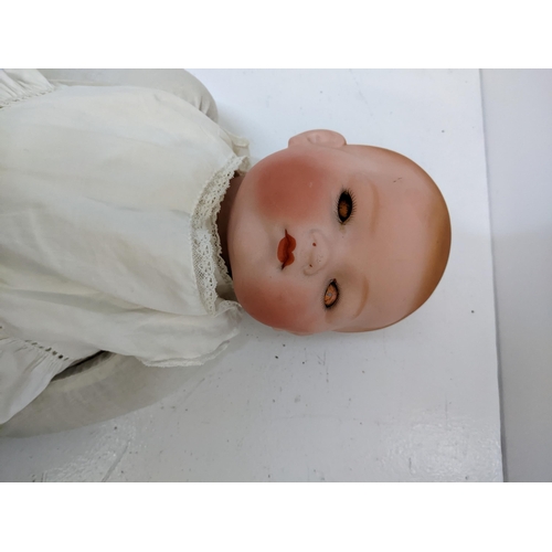 443 - An early 20th century china doll in a christening robe, marked 'A.M. Germany'
Location: 2-4
If there... 