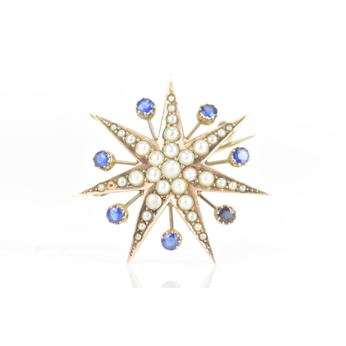 1 - An Edwardian 9ct gold split seed pearl and sapphire star brooch, seven point star with seven sapphir... 