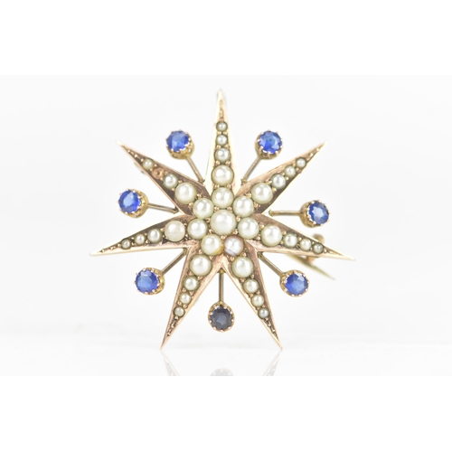 1 - An Edwardian 9ct gold split seed pearl and sapphire star brooch, seven point star with seven sapphir... 