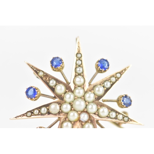 1 - An Edwardian 9ct gold split seed pearl and sapphire star brooch, seven point star with seven sapphir... 