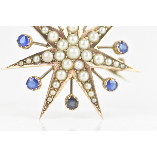 1 - An Edwardian 9ct gold split seed pearl and sapphire star brooch, seven point star with seven sapphir... 