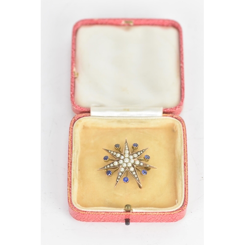 1 - An Edwardian 9ct gold split seed pearl and sapphire star brooch, seven point star with seven sapphir... 