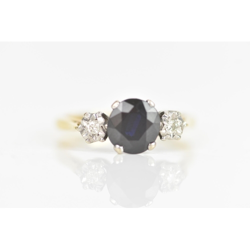 11 - A sapphire and diamond 18ct yellow and white gold engagement ring, the central sapphire calculated a... 