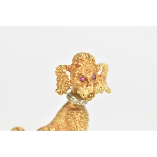 14 - An 18ct yellow and white gold brooch, fashioned as a poodle having ruby eyes, the collar inset with ... 