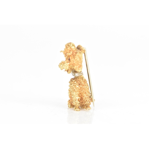 14 - An 18ct yellow and white gold brooch, fashioned as a poodle having ruby eyes, the collar inset with ... 