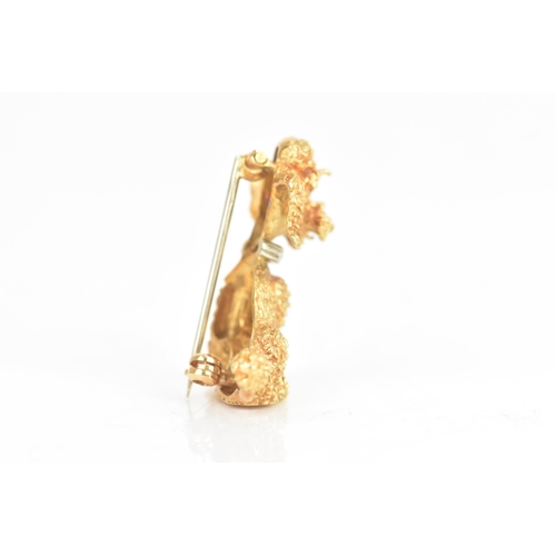 14 - An 18ct yellow and white gold brooch, fashioned as a poodle having ruby eyes, the collar inset with ... 