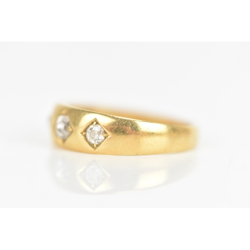 17 - A Victorian diamond 18ct yellow gold gypsy ring, set with three old cut diamonds in claw settings, t... 