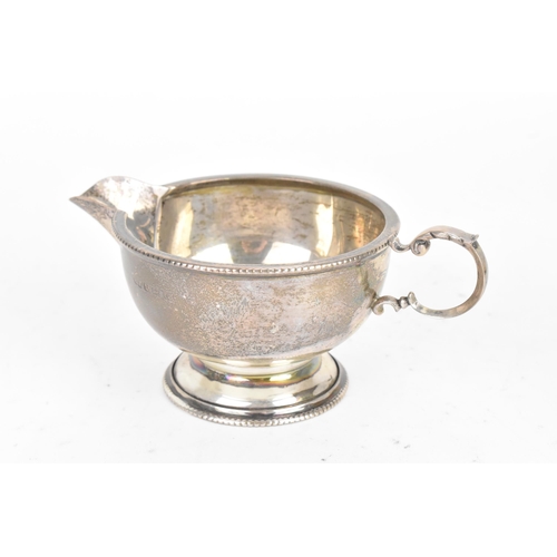 184 - A George V silver tea service, by Marson & Jones, hallmarked Birmingham 1931, the teapot having ebon... 