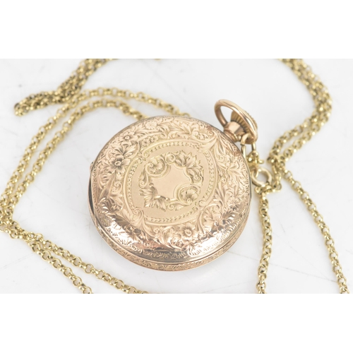 194 - An early 20th century 9ct gold keyless wound ladies fob watch, having a gilt dial with a floral spra... 