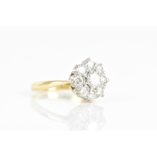 211 - A diamond 18ct gold and platinum daisy ring, the central brilliant cut diamond 3.9mm diameter, surro... 