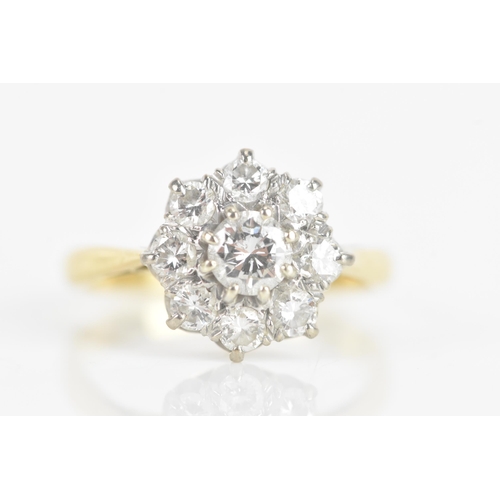 211 - A diamond 18ct gold and platinum daisy ring, the central brilliant cut diamond 3.9mm diameter, surro... 