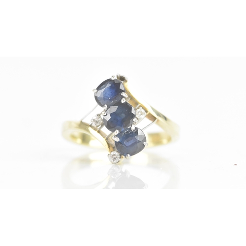 212 - A sapphire and diamond 14ct yellow and white gold dress ring, having three sapphires in four claw se... 