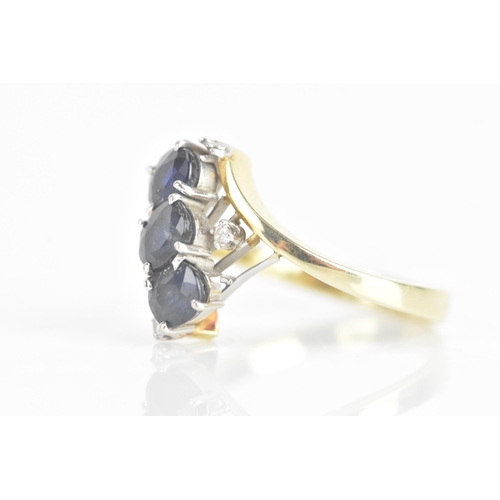 212 - A sapphire and diamond 14ct yellow and white gold dress ring, having three sapphires in four claw se... 