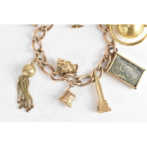 224 - A 9ct yellow gold chain link charm bracelet, with a heart shaped padlock clasp, six 9ct gold charms,... 