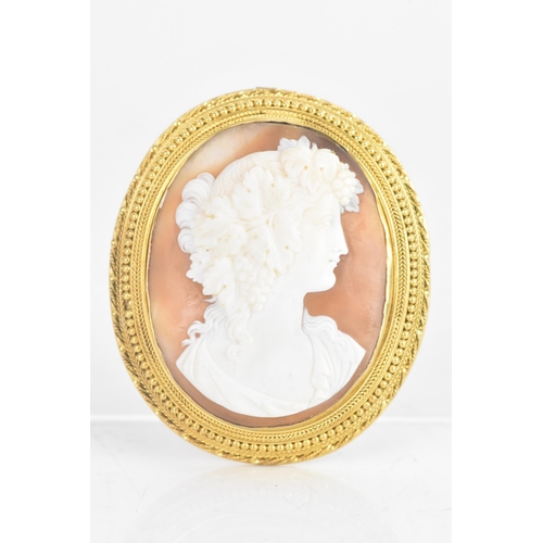 225 - A Victorian shell cameo yellow metal brooch, carved cameo depicting a classical young maiden, set in... 