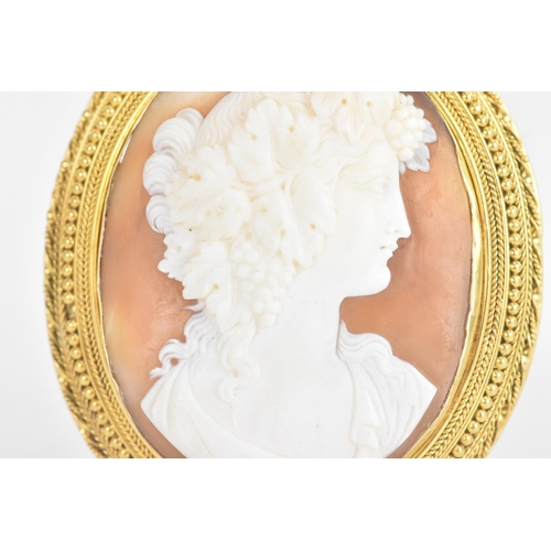 225 - A Victorian shell cameo yellow metal brooch, carved cameo depicting a classical young maiden, set in... 