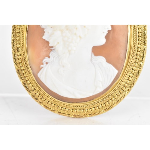 225 - A Victorian shell cameo yellow metal brooch, carved cameo depicting a classical young maiden, set in... 