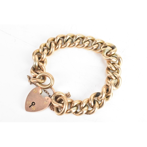 229 - An early 20th century 9ct gold curb link chain bracelet, having a 9ct gold heart shaped locket, hall... 