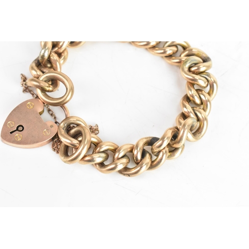 229 - An early 20th century 9ct gold curb link chain bracelet, having a 9ct gold heart shaped locket, hall... 