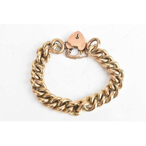 229 - An early 20th century 9ct gold curb link chain bracelet, having a 9ct gold heart shaped locket, hall... 