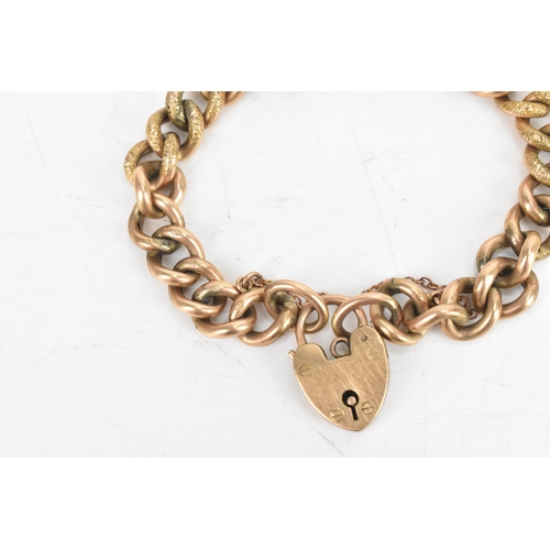 23 - A 9ct rose gold curb link chain bracelet, having a heart shaped padlock clasp and safety chain, stam... 