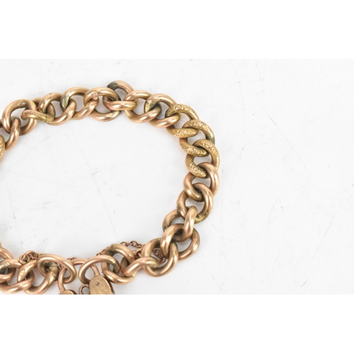 23 - A 9ct rose gold curb link chain bracelet, having a heart shaped padlock clasp and safety chain, stam... 