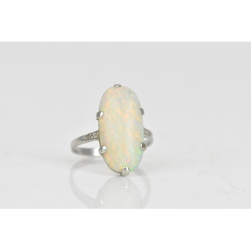 233 - An Art Deco opal and diamond platinum ring, the oval opal 19.5mm x 9.8mm, set with two rose cut diam... 