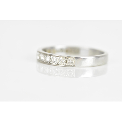 239 - A diamond 18ct white gold half eternity ring, having nine brilliant cut diamonds, each measuring app... 