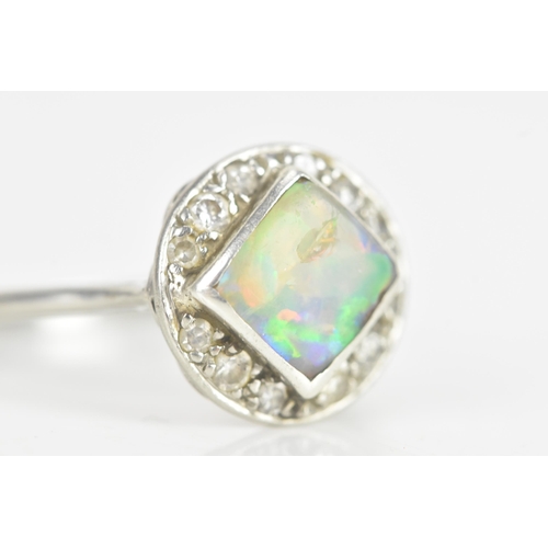 242 - An Art Deco opal platinum and diamond dress ring, the square opal measuring approximately 7mm x 7mm,... 