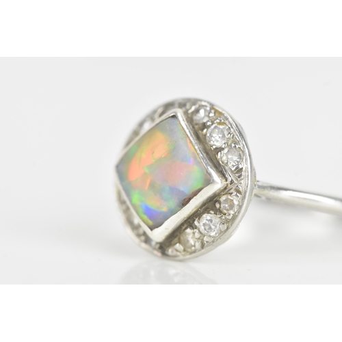 242 - An Art Deco opal platinum and diamond dress ring, the square opal measuring approximately 7mm x 7mm,... 