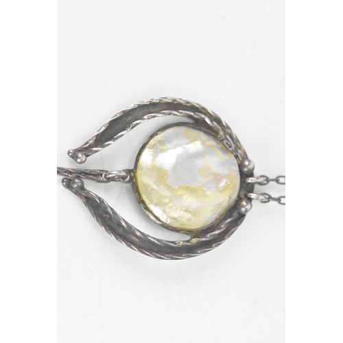 248 - An Arts & Crafts mother of pearl necklace white metal necklace, the pendant with three pearl cabocho... 