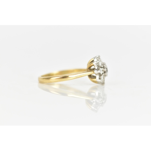 28 - A diamond 18ct yellow gold cluster daisy ring, the central brilliant cut diamond 3.5mm diameter, in ... 