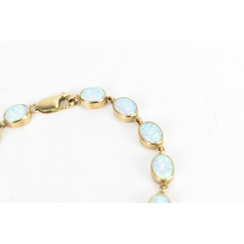 32 - An opal 9ct gold bracelet, the fourteen oval opals colet set, stamped 375, 19cm, 11.7 grams
If there... 