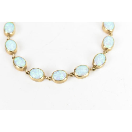 32 - An opal 9ct gold bracelet, the fourteen oval opals colet set, stamped 375, 19cm, 11.7 grams
If there... 