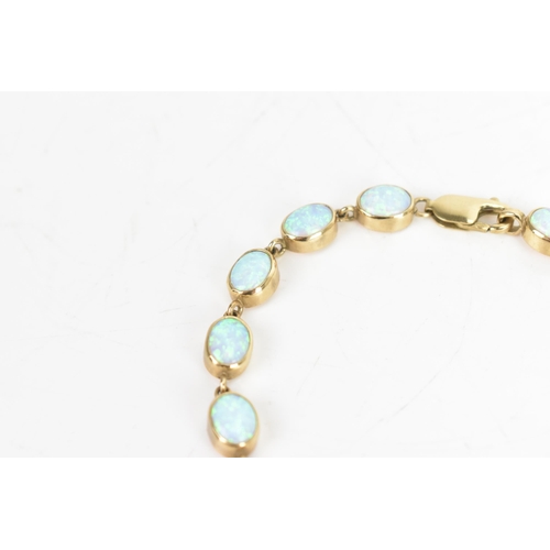 32 - An opal 9ct gold bracelet, the fourteen oval opals colet set, stamped 375, 19cm, 11.7 grams
If there... 