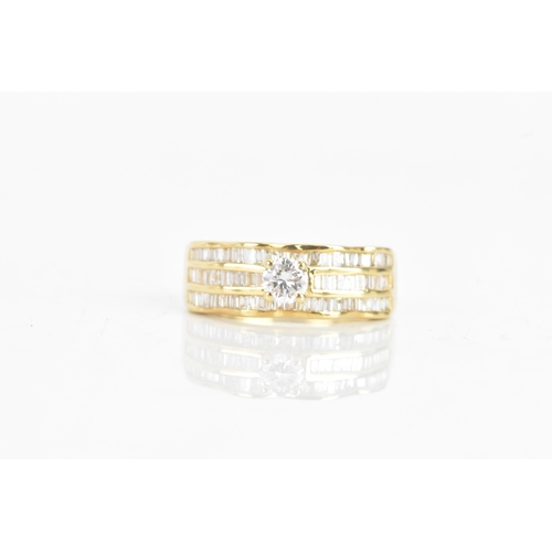 35 - A diamond and 18ct yellow gold ring set, the engagement ring having a brilliant cut diamond, calcula... 