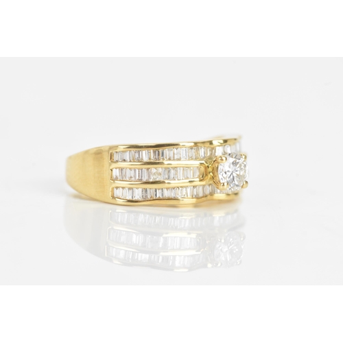 35 - A diamond and 18ct yellow gold ring set, the engagement ring having a brilliant cut diamond, calcula... 