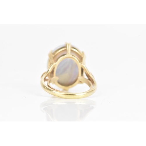 42 - An opal yellow gold ring, the oval opal in a six claw setting, 16.5mm x 14mm, having a pierced galle... 