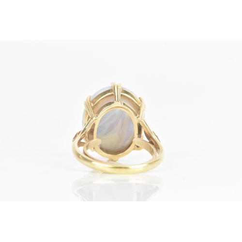 42 - An opal yellow gold ring, the oval opal in a six claw setting, 16.5mm x 14mm, having a pierced galle... 