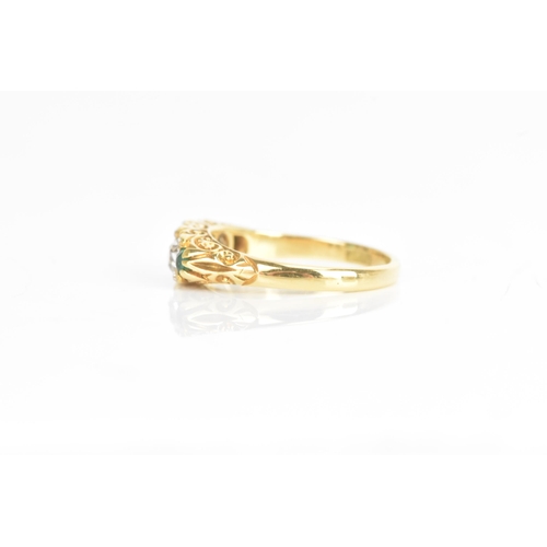 43 - A Victorian emerald and diamond 18ct yellow gold ring, having three emeralds flanking two old cut di... 