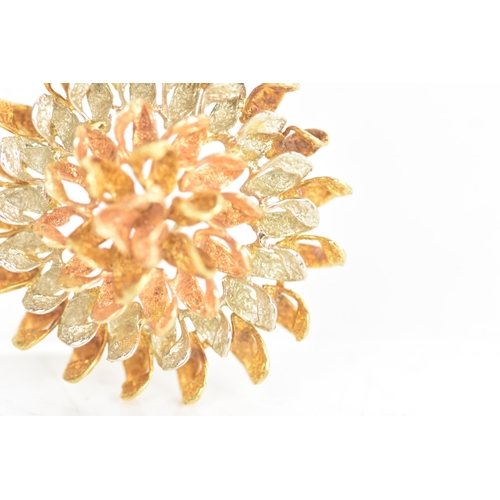 45 - An 18ct tri-coloured gold brooch, fashioned as a flower head, stamped 18K to the reverse, 15.5 grams... 