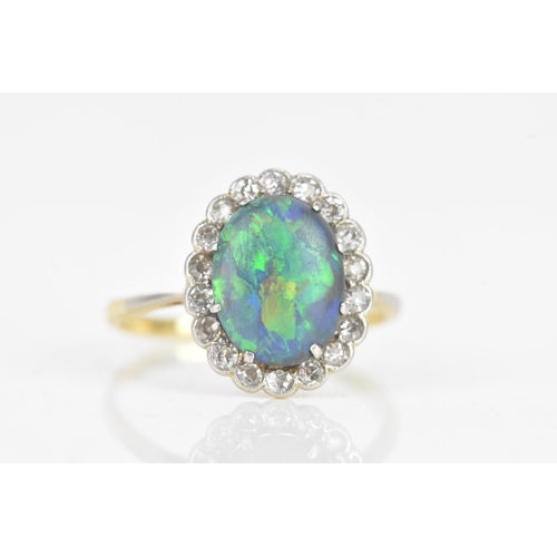 50 - A late 19th/early 20th century opal and diamond cluster yellow gold ring, the central oval opal 10.5... 