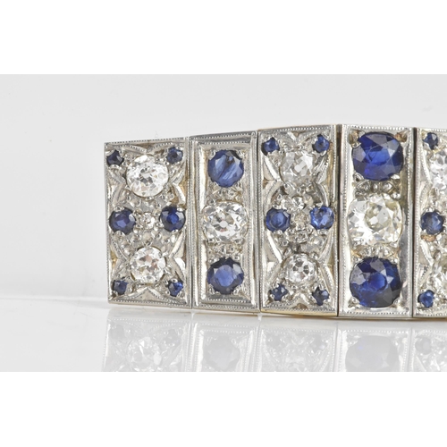 56 - An Art Deco diamond and sapphire white metal part bracelet, composed of seven flexible graduating li... 