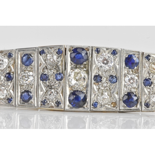 56 - An Art Deco diamond and sapphire white metal part bracelet, composed of seven flexible graduating li... 