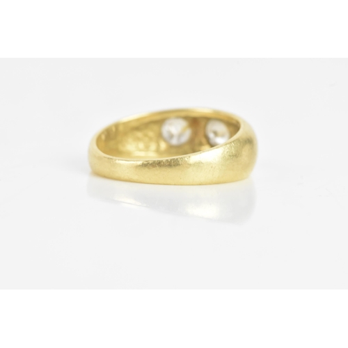 57 - A diamond 18ct yellow gold gypsy ring, having three brilliant cut diamonds in claw settings, the cen... 