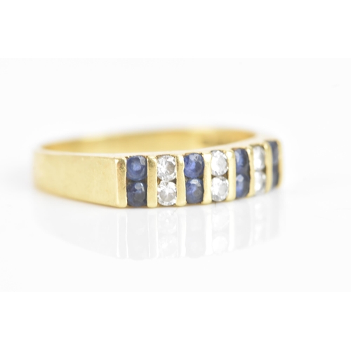 58 - A diamond and sapphire 18ct yellow gold ring, set with six brilliant cut diamonds flanked by eight s... 