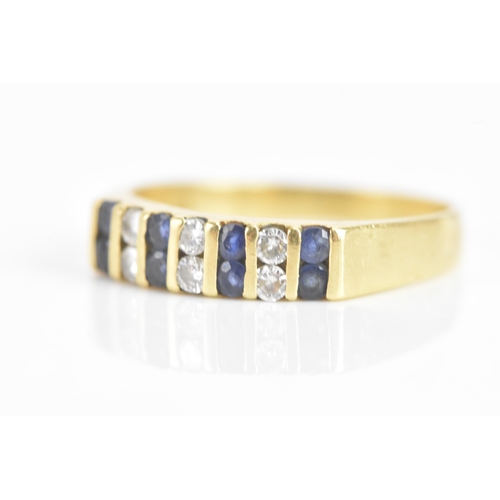 58 - A diamond and sapphire 18ct yellow gold ring, set with six brilliant cut diamonds flanked by eight s... 