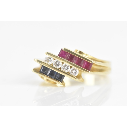 60 - A diamond, sapphire and ruby 14ct yellow gold dress ring, having four channel set central brilliant ... 