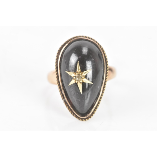 61 - A Victorian garnet cabochon and diamond yellow gold star ring, the central tear-drop garnet centred ... 